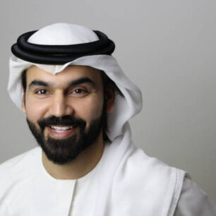 Portrait Of An An Arab Businessman Smiling Facing The Camera Proudly And Wearing UAE Traditional Dress